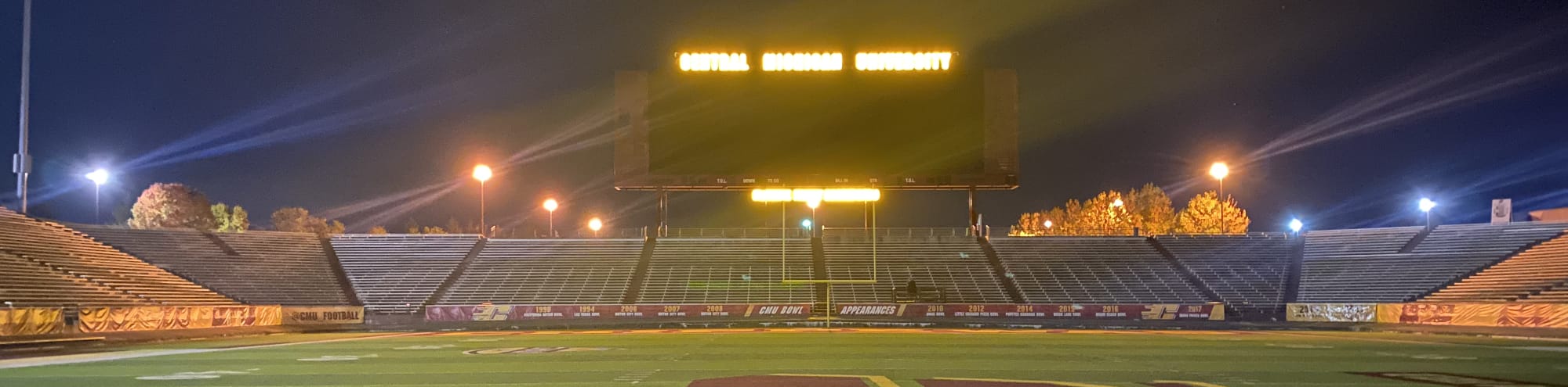 empty football stadium at night under the lights Savannah