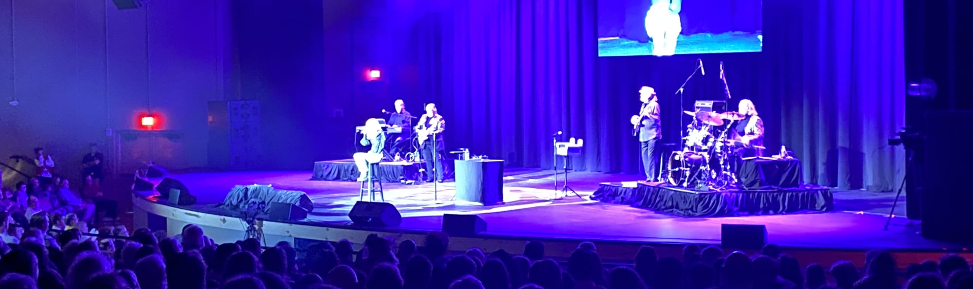 signer on stage in chair washed out by the lights Savannah